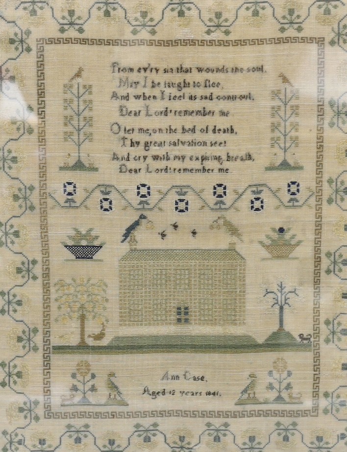 An early Victorian sampler, dated 1841 by Ann Case, embroidered with a house, trees, a dog and birds, in Maple frame, 42cms wide x 51cms high (including frame)